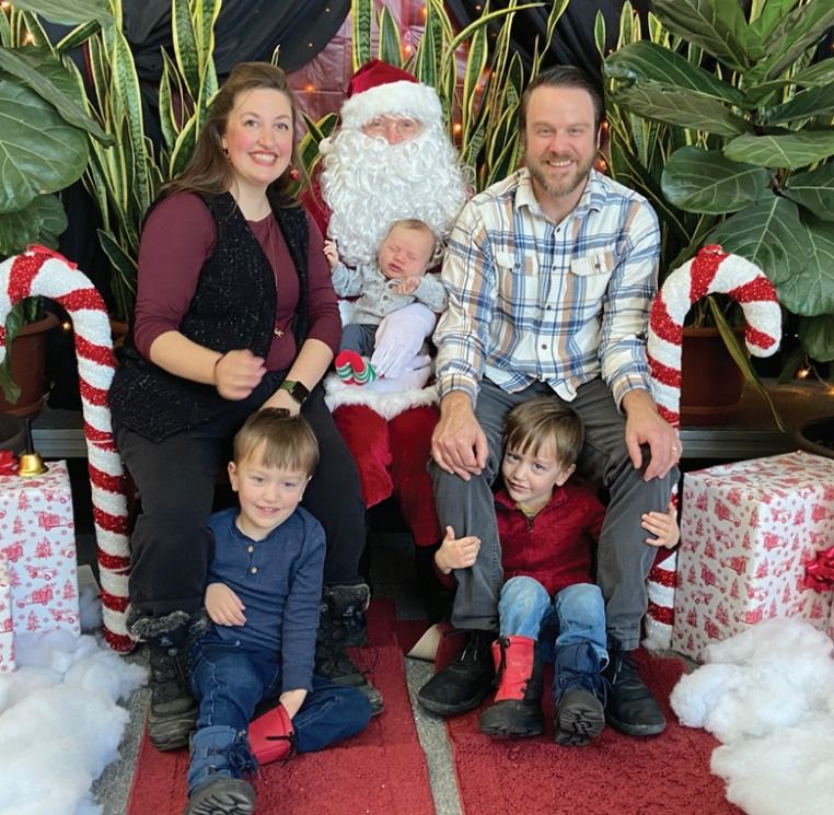 a man and a woman with their twin sons